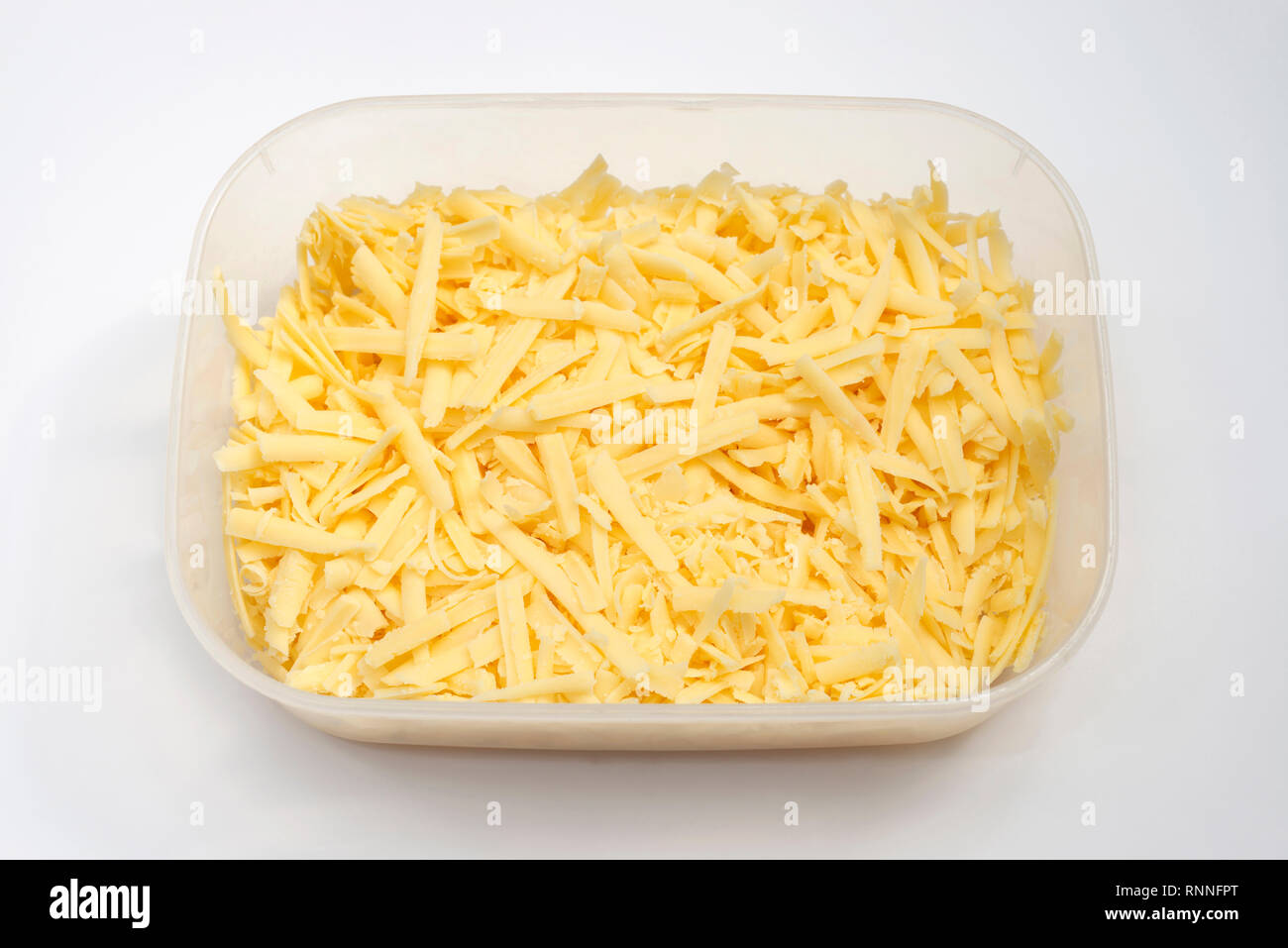 Grated cheddar cheese in plastic container Stock Photo - Alamy