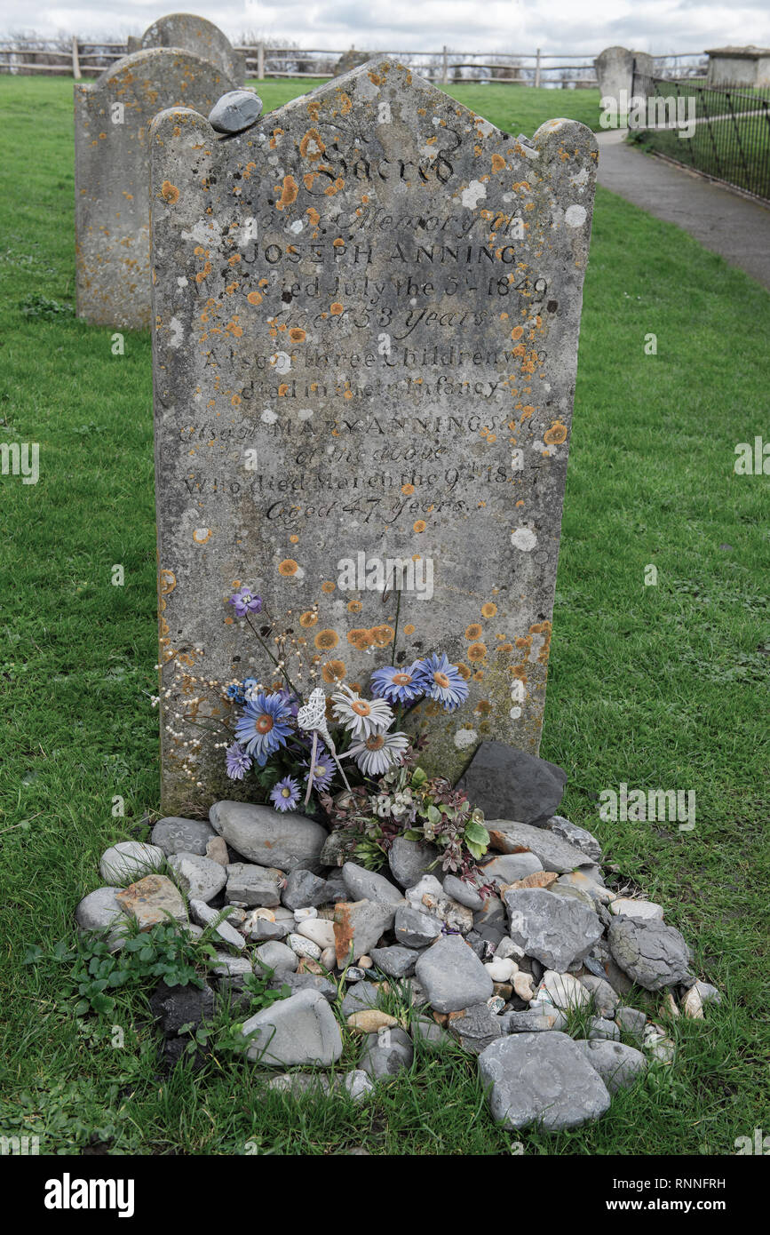 The original gravestone of Mary Anning before it was replaced in 2019. Visitors like to place fossils on the grave instead of flowers in her memory. Stock Photo