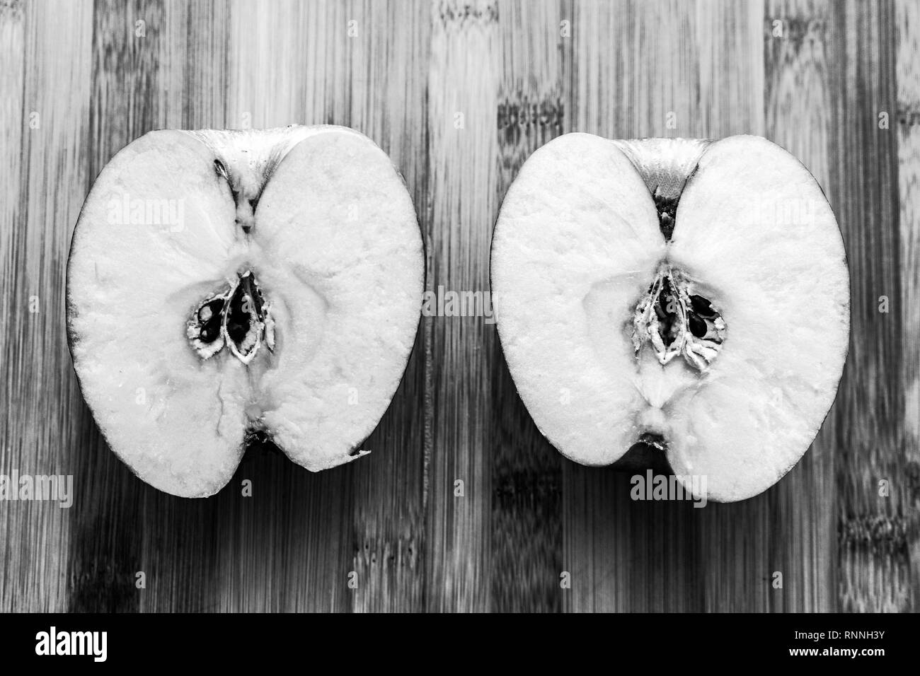 Sliced apple on bamboo cutting board with knife Stock Photo