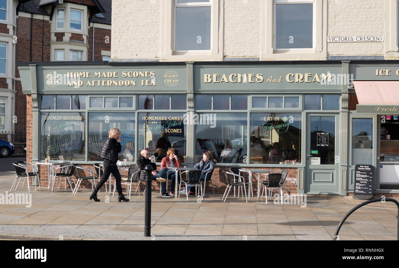 People sitting outside the Beaches and Cream cafe in Cullercoats, north