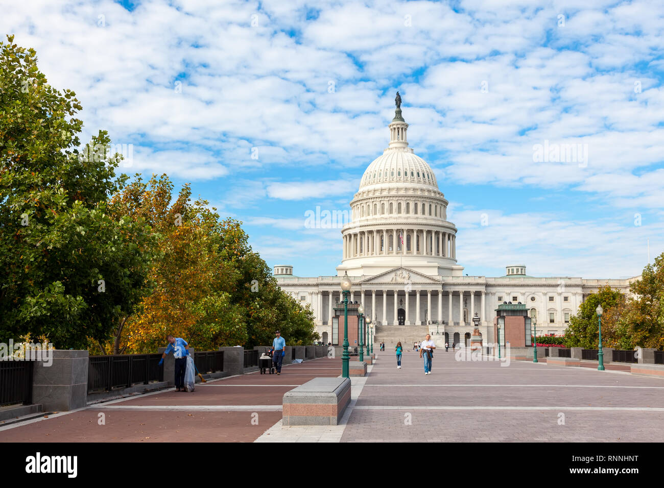 Washington DC, USA : Capitol USA Building at day. People tourists on background of east front at day. White feather clouds and blue Stock Photo