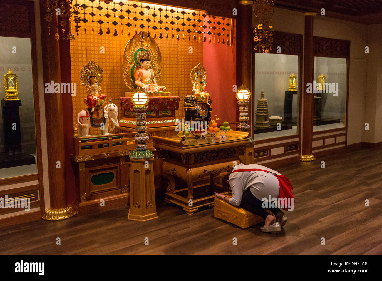Worshiper Praying before an Altar, Buddha Tooth Relic Temple, Singapore. Stock Photo