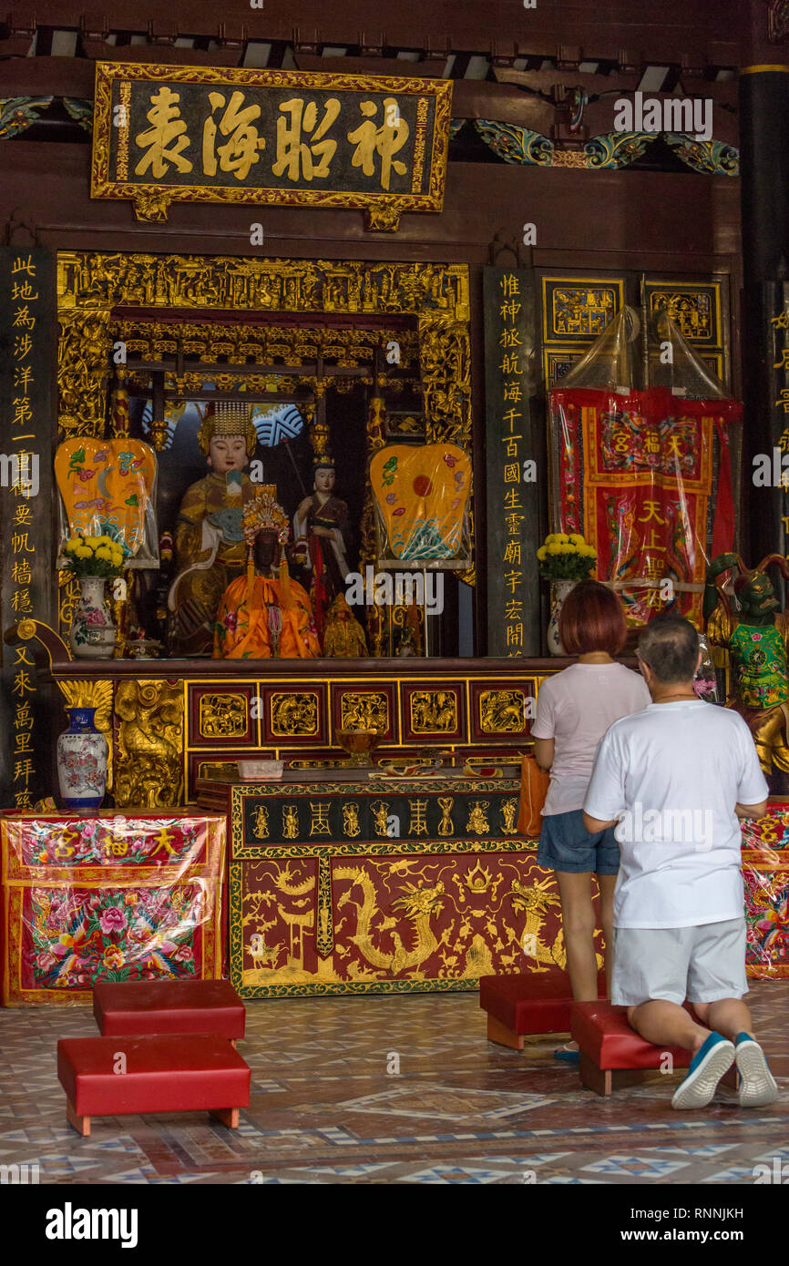 Singapore Thian Hock Keng Taoist Temple, Worshipers Praying before Shrine to Ma Zu Guardian of the South Seas. Stock Photo