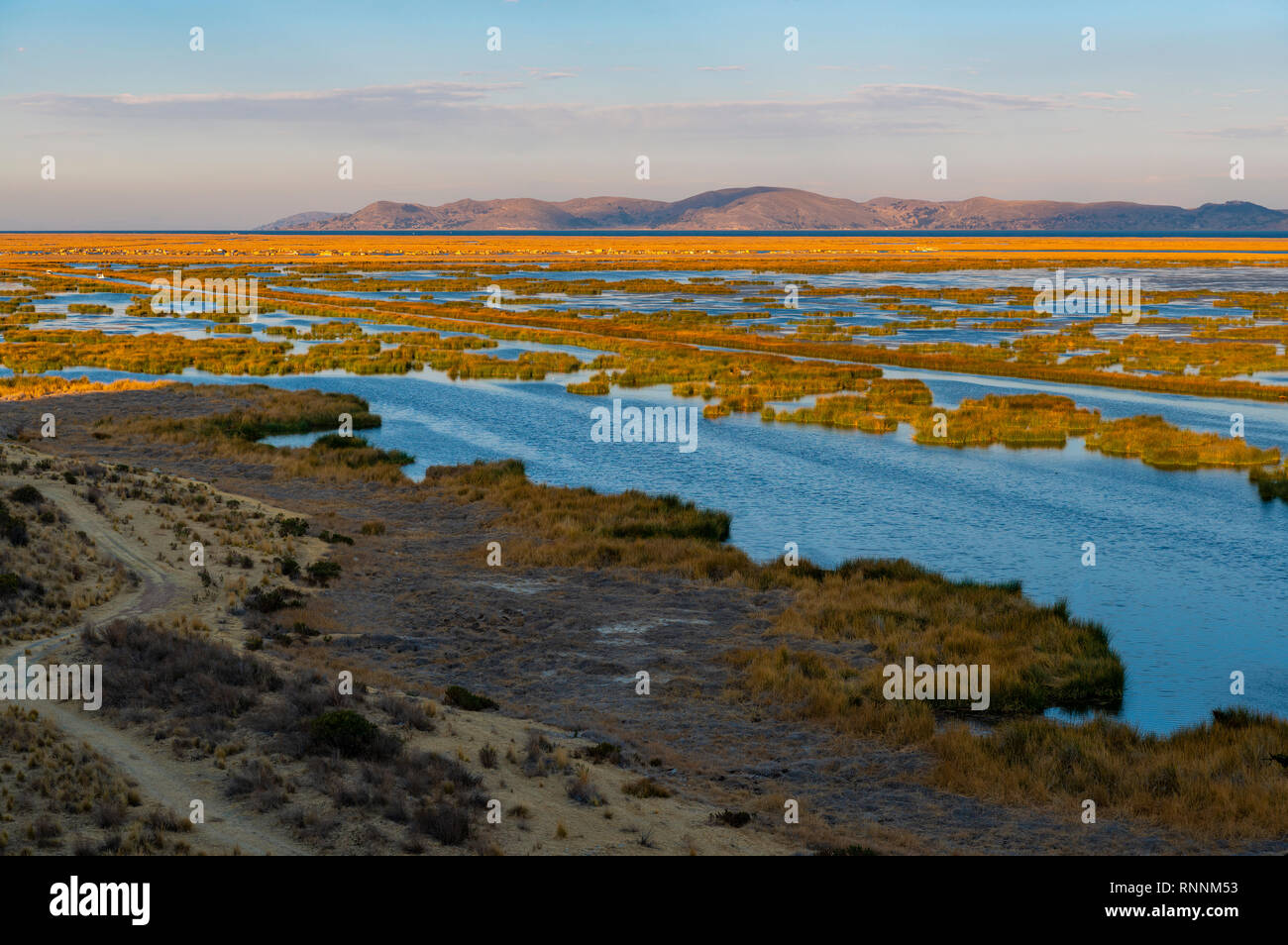 Sunrise on the Titicaca Lake near the city of Puno with a view over the totora reed floating islands of the Uros indigenous group, Peru. Stock Photo
