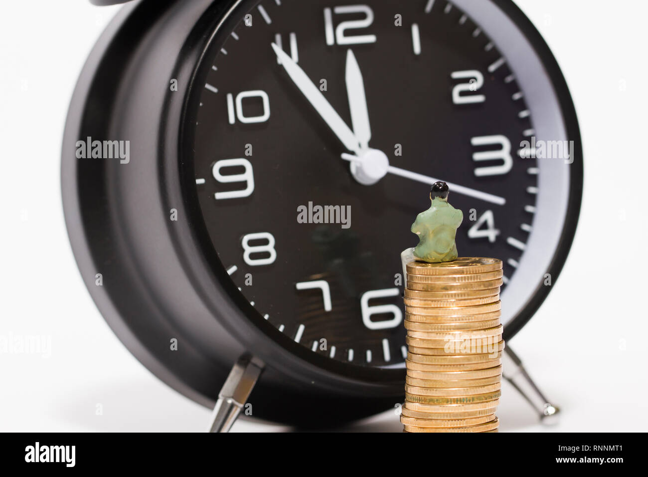 An alarm clock and accumulation of wealth Stock Photo