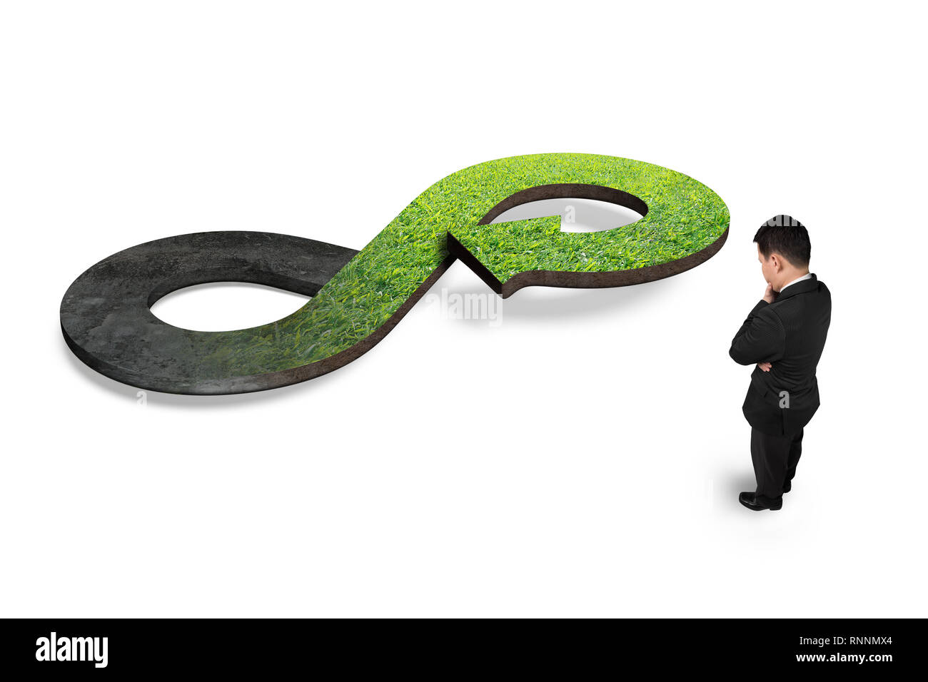 Green circular economy concept. Man looking at arrow infinity symbol with grass, isolated on white. Stock Photo