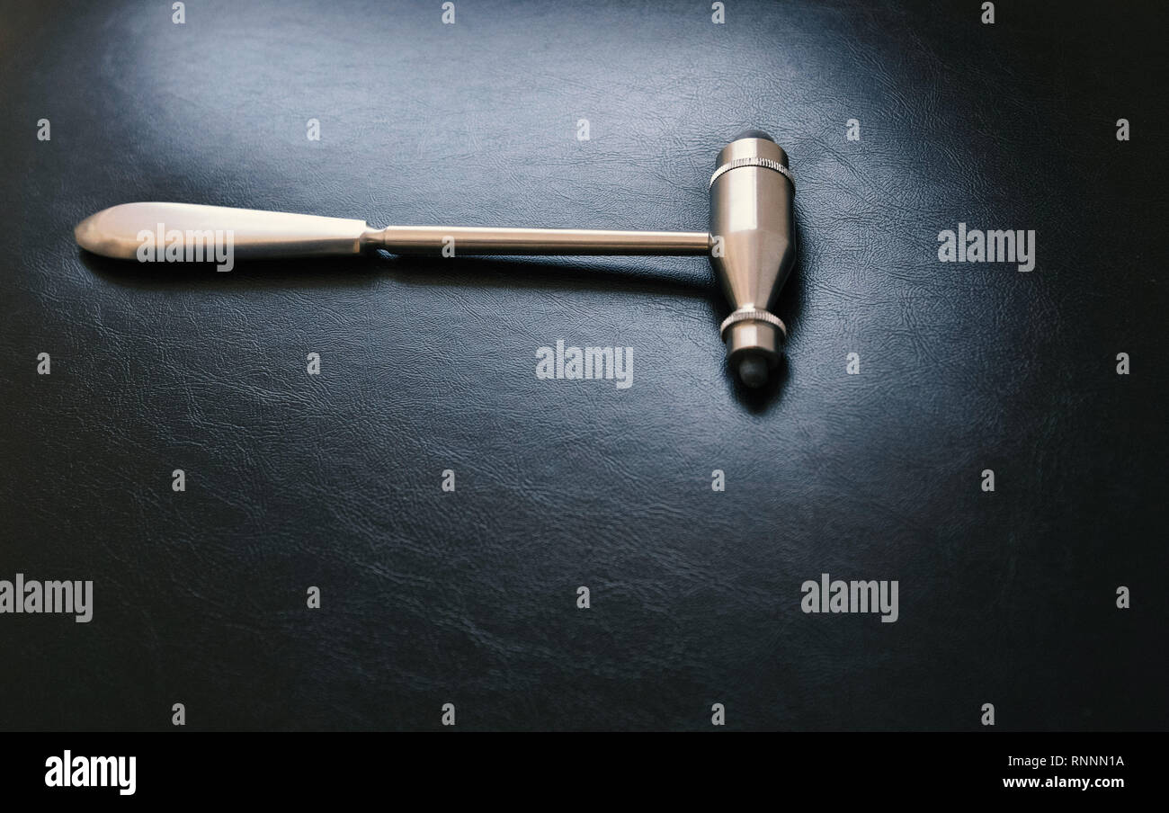Physician tool, doctor hammer on black leather Stock Photo Alamy
