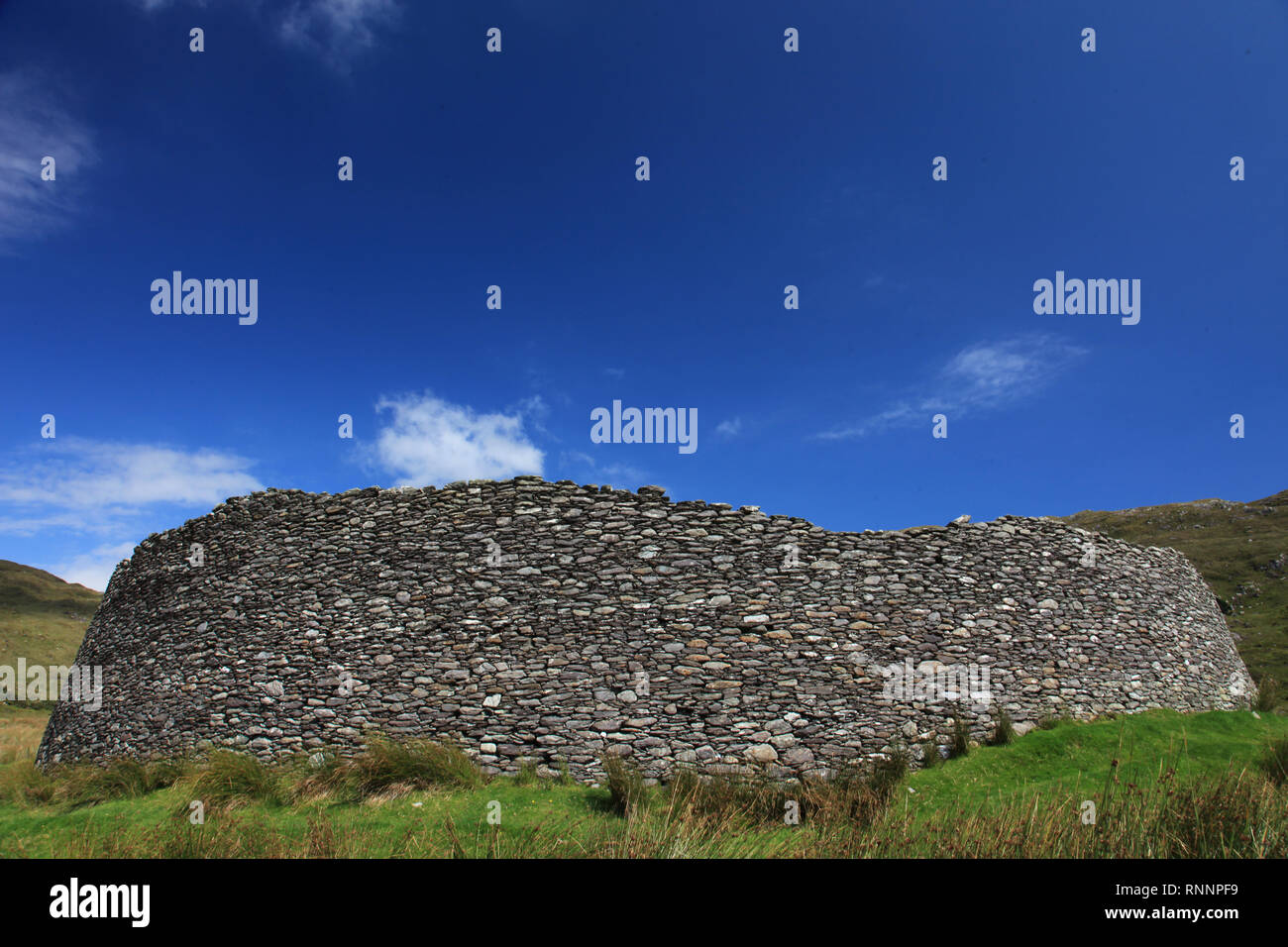 round stone built fort perched under high mountain, wild atlantic way, county kerry, ireland Stock Photo