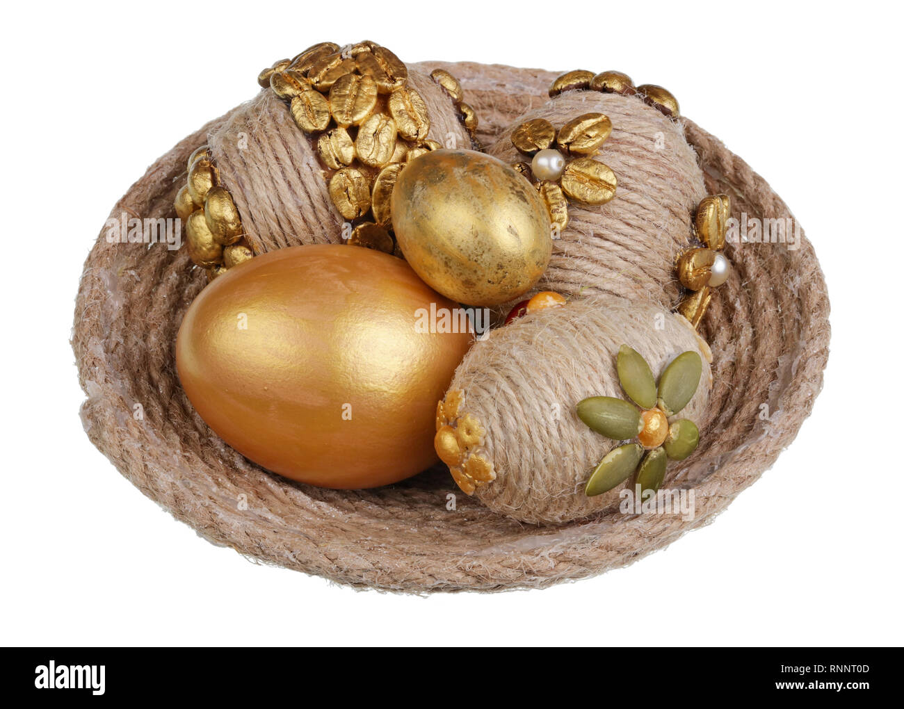 Easter handmade eggs made from golden coffee beans and vegetables seeds. Isolated on white macro Stock Photo