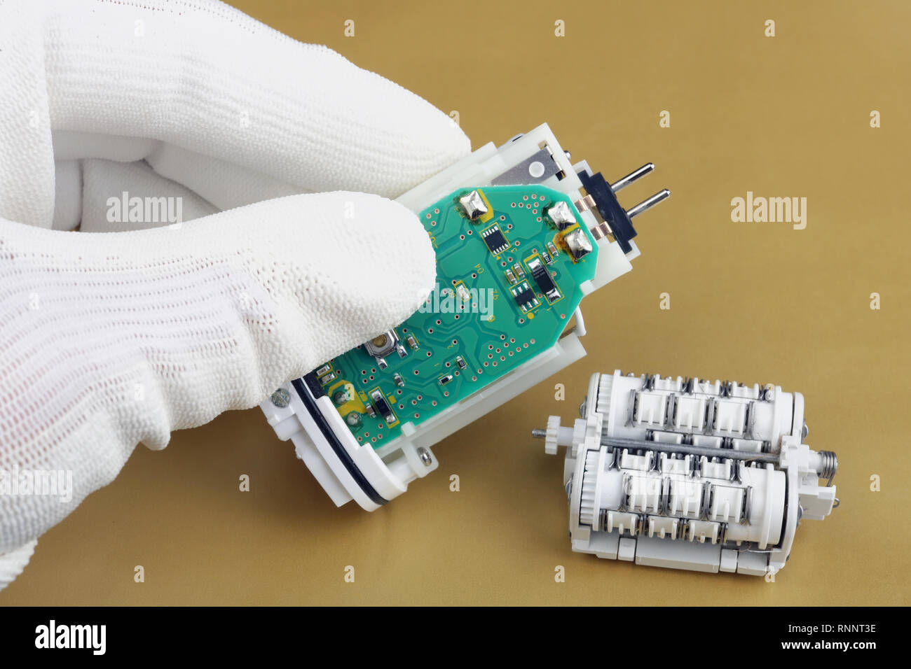 Technician repair the used epilator- electro mechanical device with battery  and motor. Macc production. Studio macro concept Stock Photo - Alamy