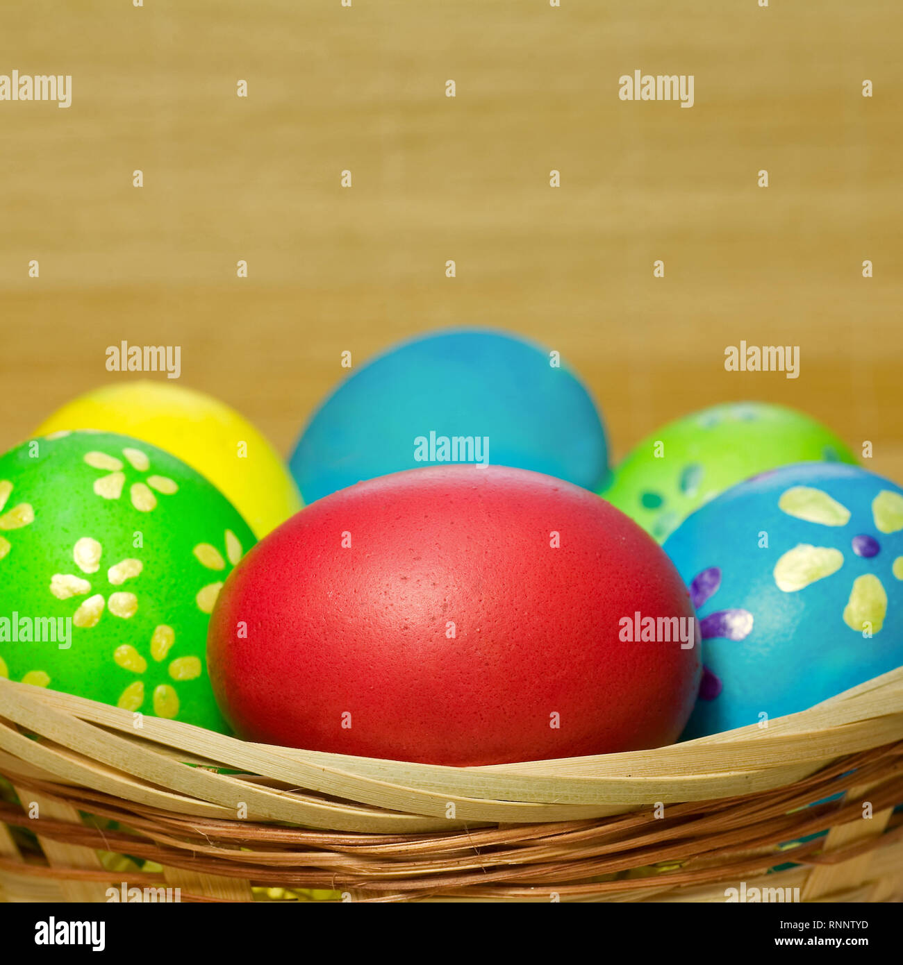 Colored eggs in basket Stock Photo Alamy