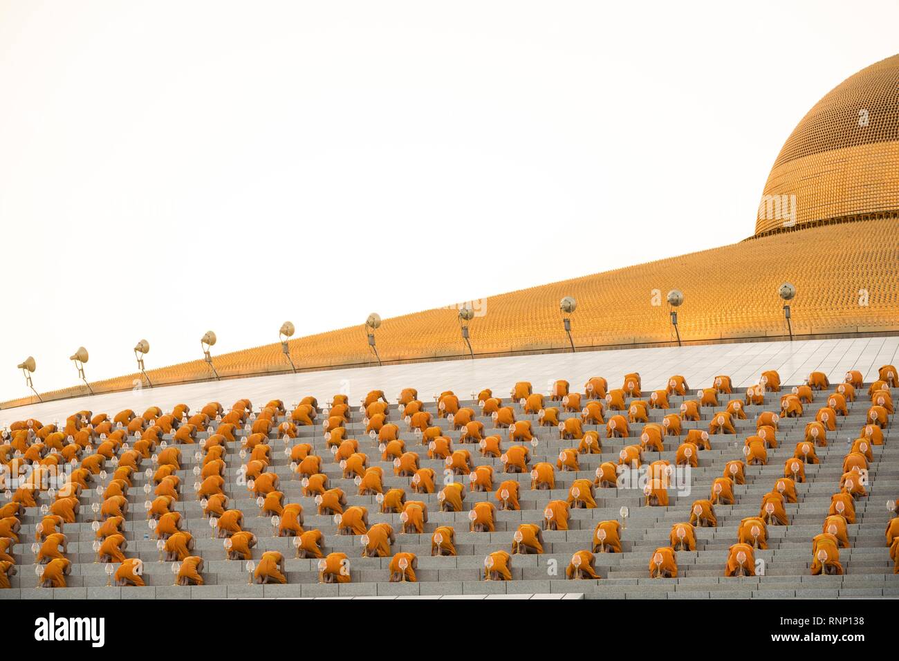 Bangkok, Thailand. 19th Feb, 2019. Monks seen praying while holding lanterns during the yearly Makha Bucha ceremony. Buddhist devotees celebrate the annual festival of Makha Bucha, one of the most important day for buddhists around the world. More than a thousand monks and hundred of thousand devotees were gathering at Dhammakaya Temple in Bangkok to attend the lighting ceremony. Credit: Geovien So/SOPA Images/ZUMA Wire/Alamy Live News Stock Photo