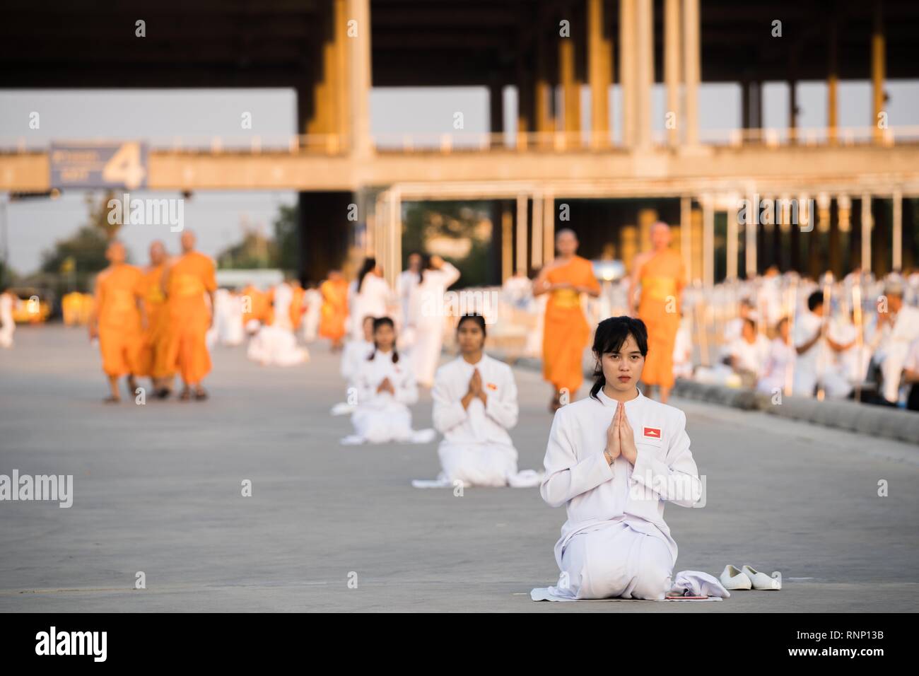 Bangkok, Thailand. 19th Feb, 2019. A woman seen meditating during the yearly Makha Bucha ceremony. Buddhist devotees celebrate the annual festival of Makha Bucha, one of the most important day for buddhists around the world. More than a thousand monks and hundred of thousand devotees were gathering at Dhammakaya Temple in Bangkok to attend the lighting ceremony Credit: Geovien So/SOPA Images/ZUMA Wire/Alamy Live News Stock Photo