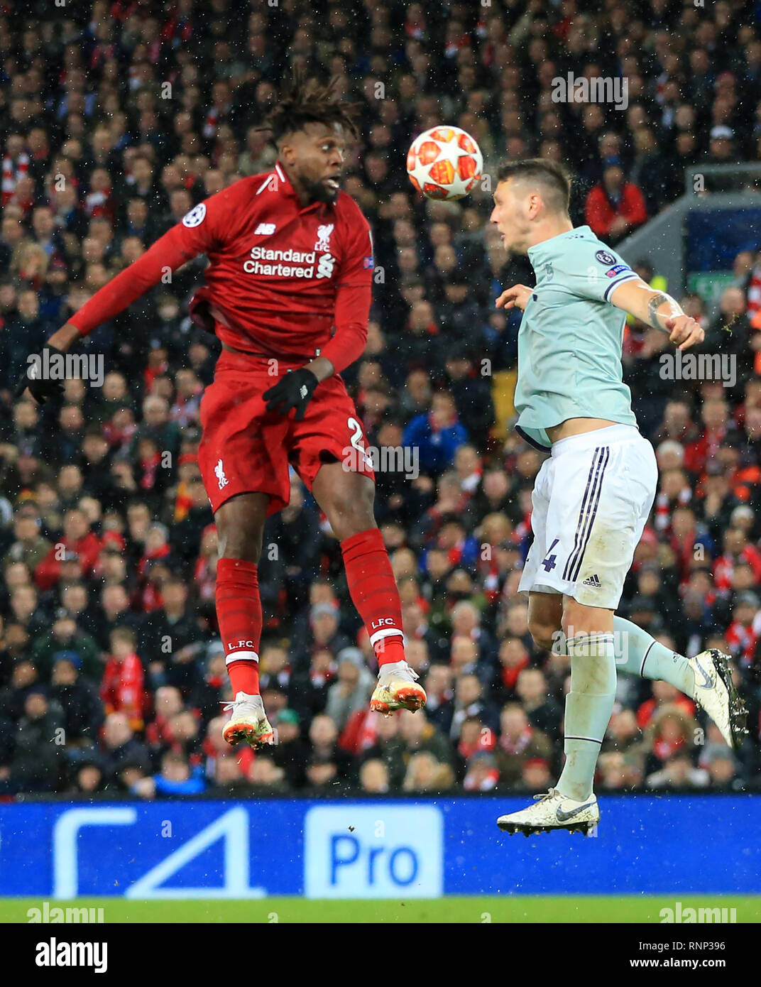Anfield, Liverpool, UK. 19th Feb, 2019. UEFA Champions League round of 16, Liverpool versus Bayern Munich; Niklas Sule of Bayern Munich wins a header challenged by Divock Origi of Liverpool Credit: Action Plus Sports/Alamy Live News Stock Photo