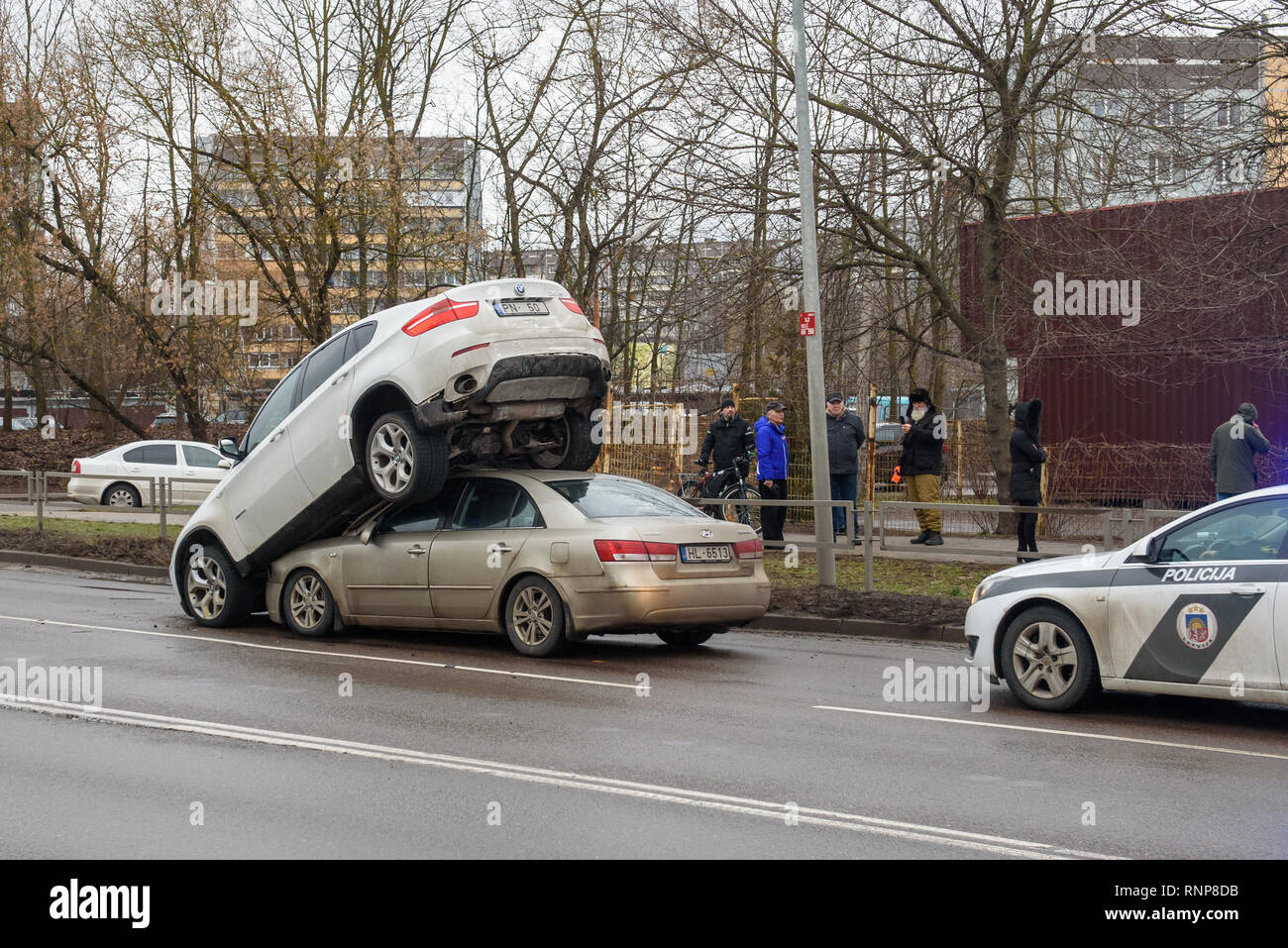 Riga, Latvia. 20th Feb 2019. Car accident - BMW and Hyundai. Strange situation, BMW car is on the roof on Hyundai car. Possibly BMW was a stolen car. Credit: Gints Ivuskans/Alamy Live News Stock Photo