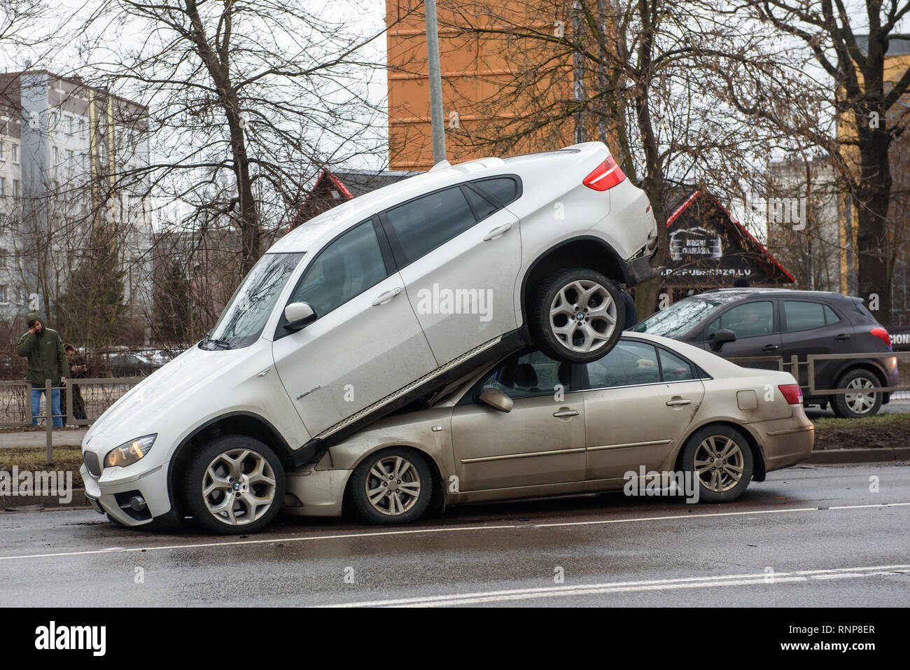 Riga, Latvia. 20th Feb 2019. Car accident - BMW and Hyundai. Strange  situation, BMW car is on the roof on Hyundai car. Possibly BMW was a stolen  car. Credit: Gints Ivuskans/Alamy Live