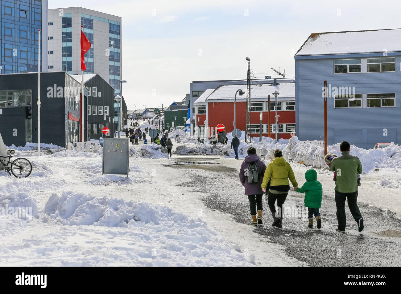 Central pedestrian street with modern building and walking people of Nuuk city, Greenland Stock Photo