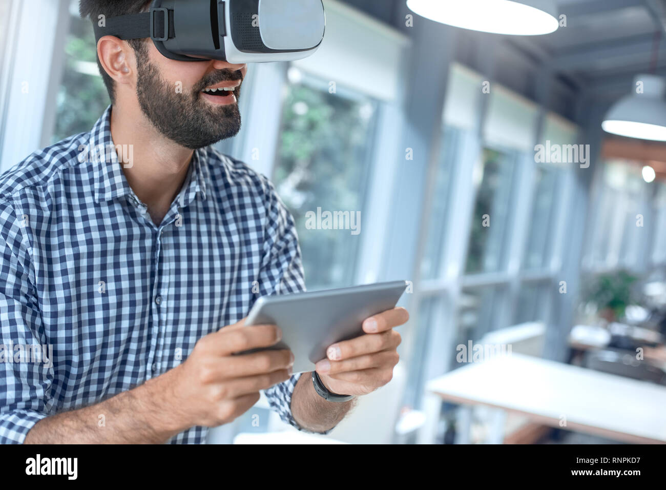 Business person using virtual reality headset holding digital tablet Stock Photo