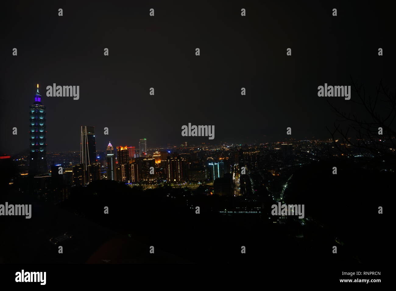 The aerial night view of the Taipei 101 from Elephant moutain (Xiangshan) in Taiwan. The concept of friendly and convenient lifestyle for real estate. Stock Photo