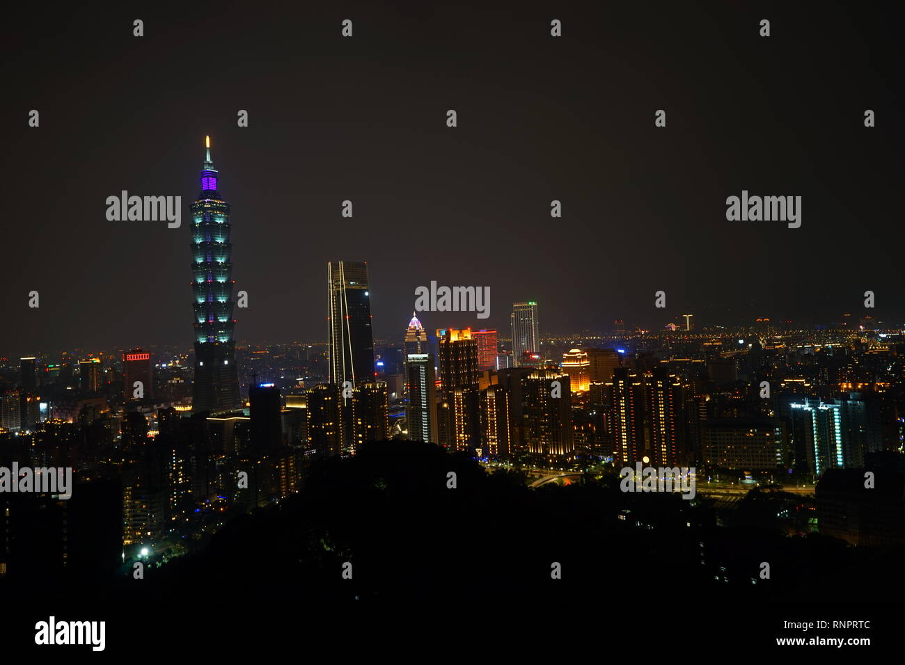 The aerial night view of the Taipei 101 from Elephant moutain (Xiangshan) in Taiwan. The concept of friendly and convenient lifestyle for real estate. Stock Photo