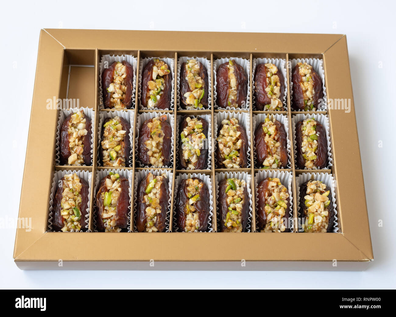 Dates stuffed with pistachios in a box Stock Photo