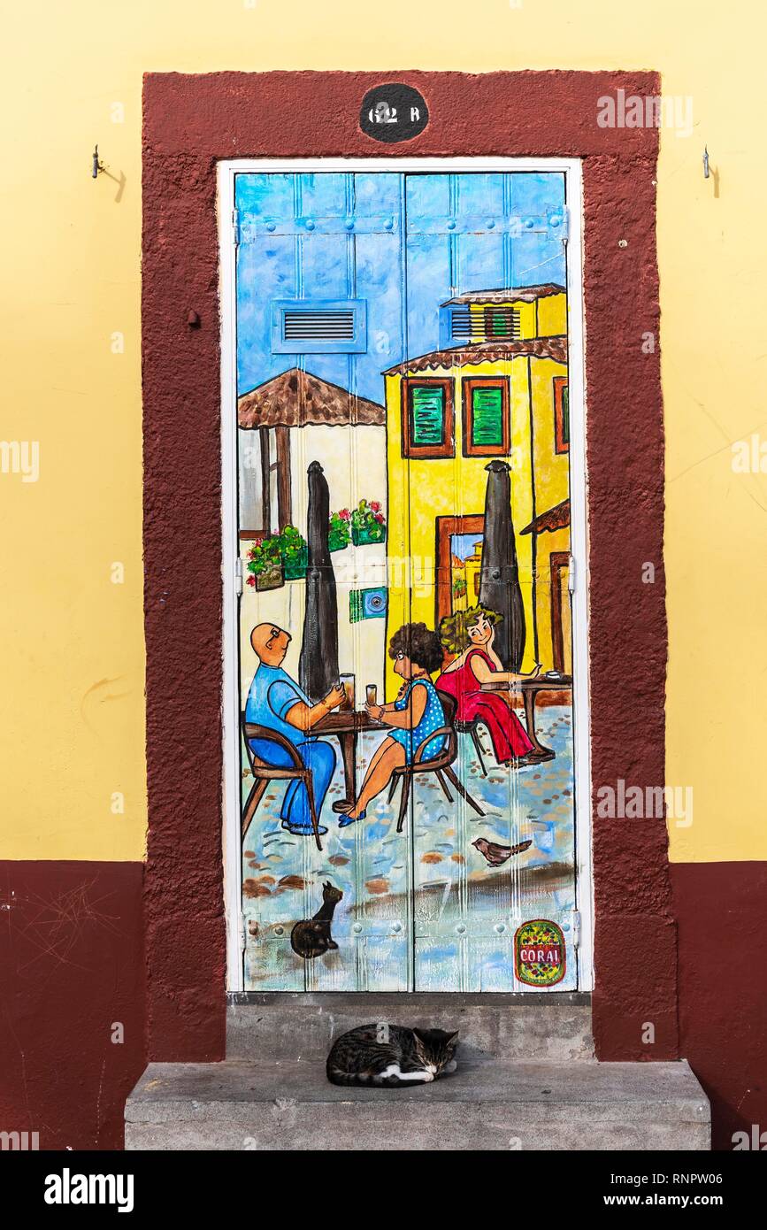 Woman, man, cat, street scene, artistically painted front door, painting, street art, Funchal, Madeira, Portugal Stock Photo