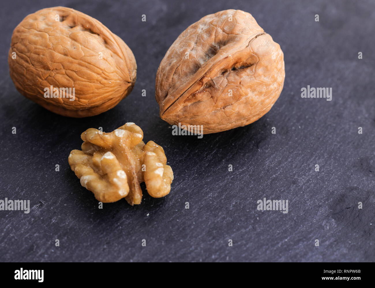 Walnuts on black surface Stock Photo