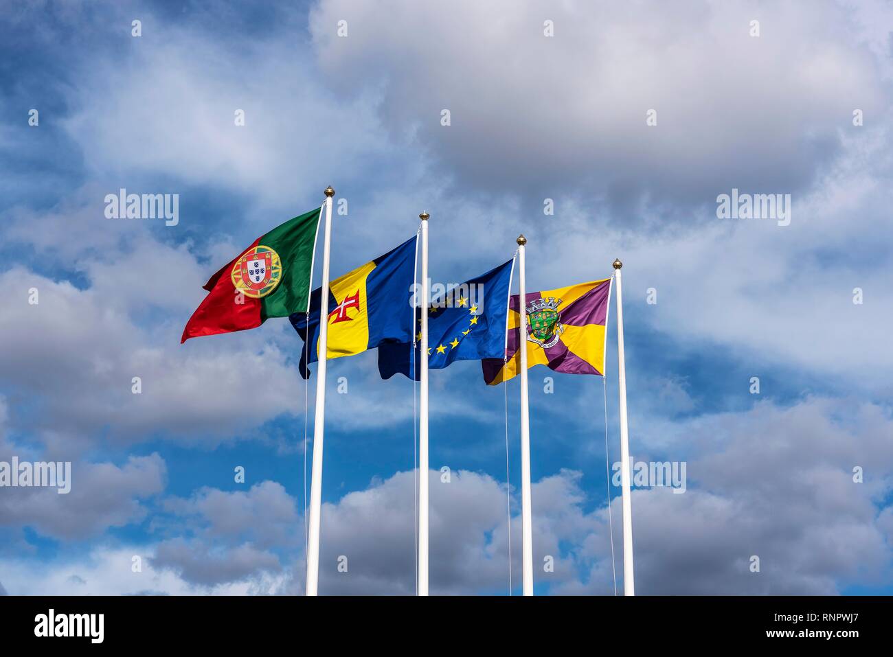 Flags of Portugal, Madeira and Funchal blowing in the wind, Island Madeira, Portugal Stock Photo