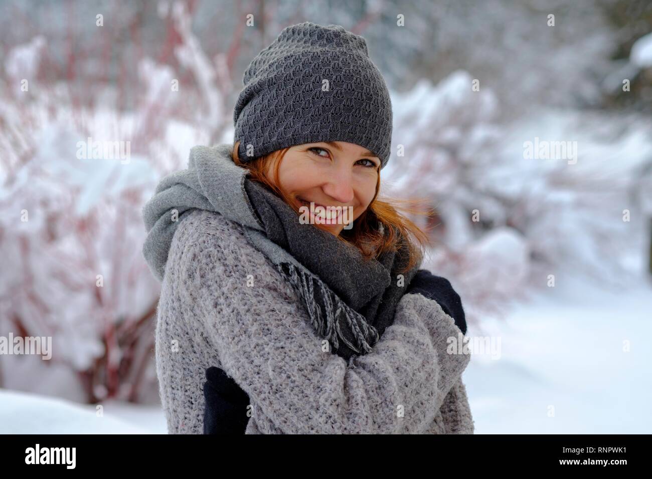 Girl with cap and scarf in winter in the snow, Upper Bavaria, Bavaria, Germany Stock Photo