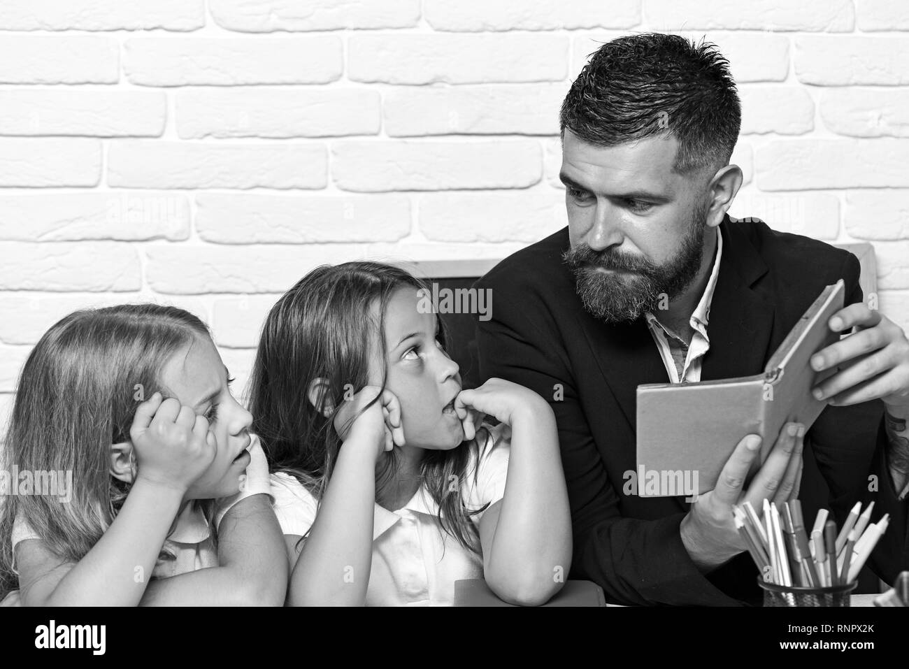 reading a story. father read book to his daughters. Stock Photo