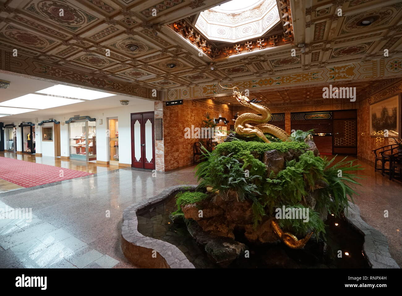 The magnificent statue of golden dragon inside the Grand Hotel. Stock Photo