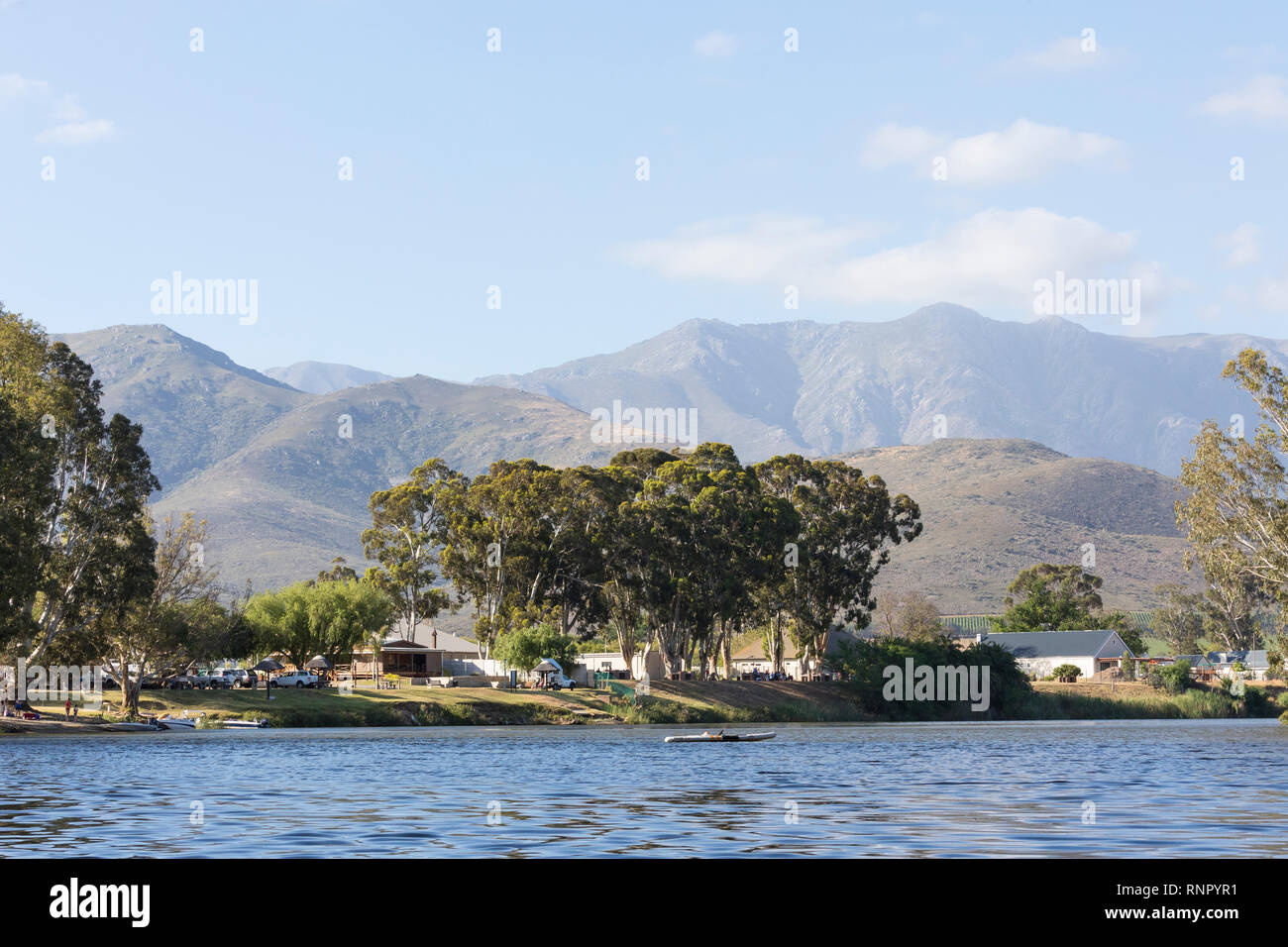 Robertson caravan park on the bank of the Breede River, Robertson, Boland, Western Cape, South Africa against the Langeberg Mountains in evening light Stock Photo