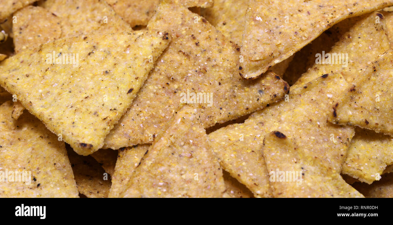 background of many triangles of Tortillas chips a very good salty snack