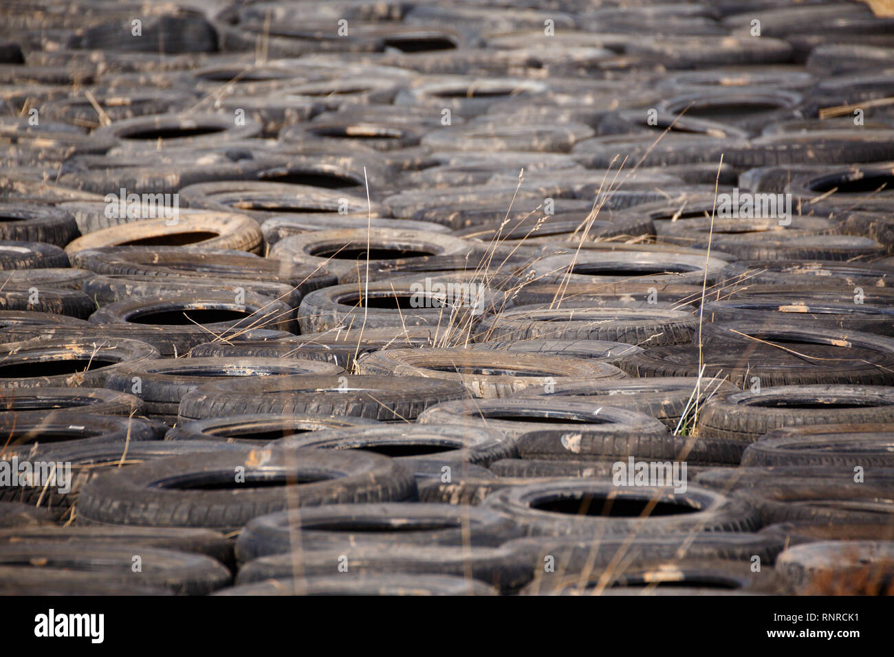 Old used tires dump pollution and disposal Stock Photo