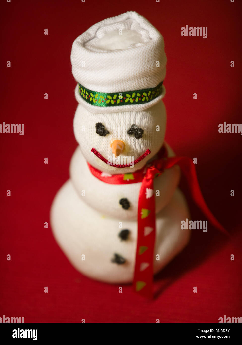 Handmade snowman doll over red Stock Photo