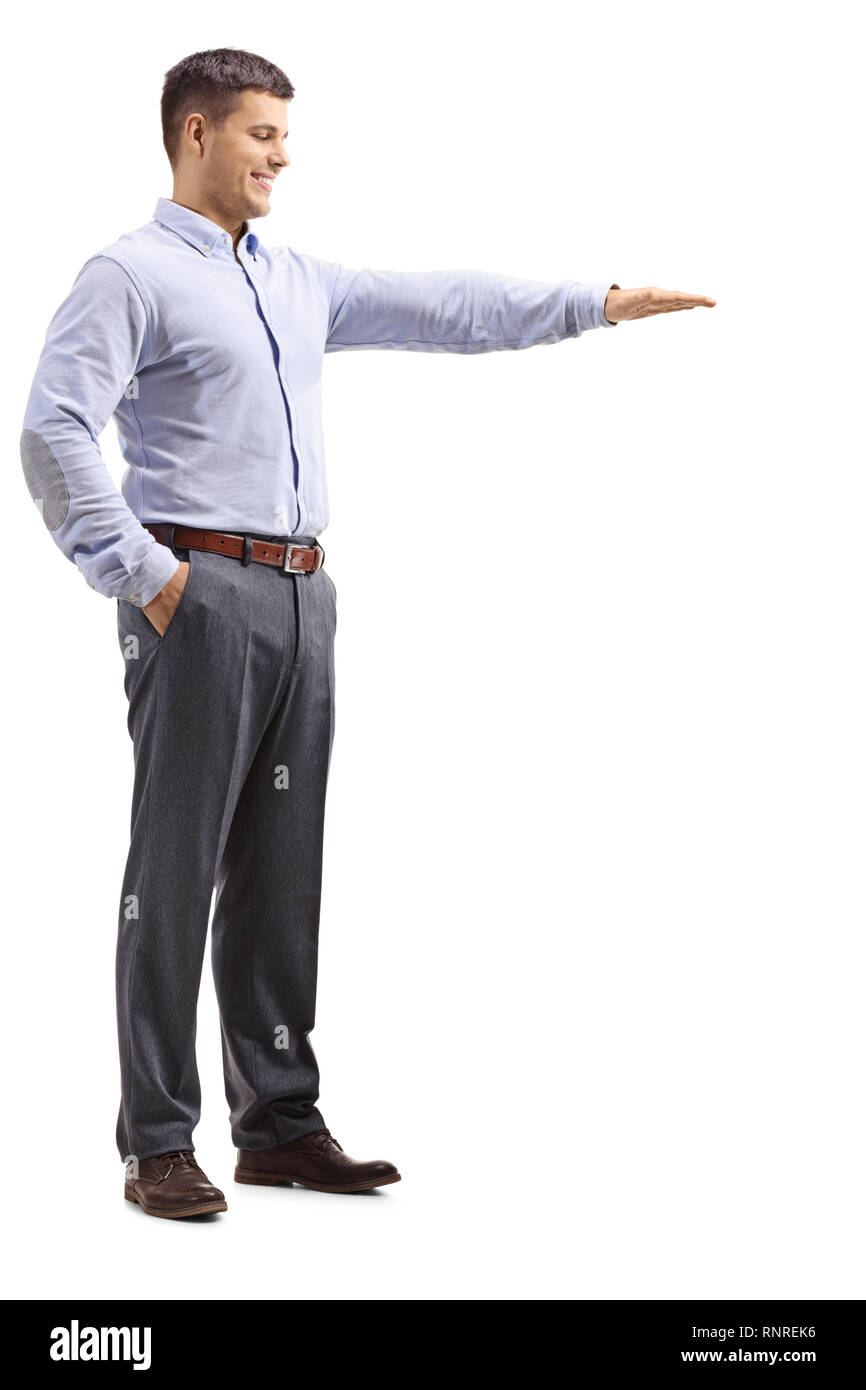Full length shot of a young man in formal clotes gesturing with hand and showing the height of something isolated on white background Stock Photo