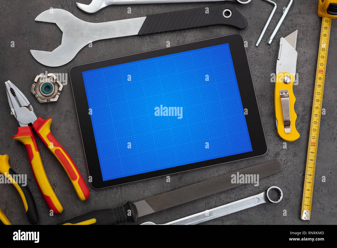 Household tools and tablet with grid screen concept Stock Photo
