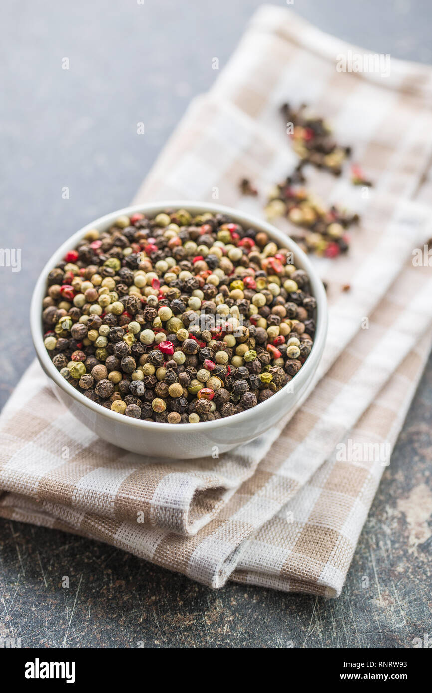 Different types of dried peppercorn in bowl. Stock Photo