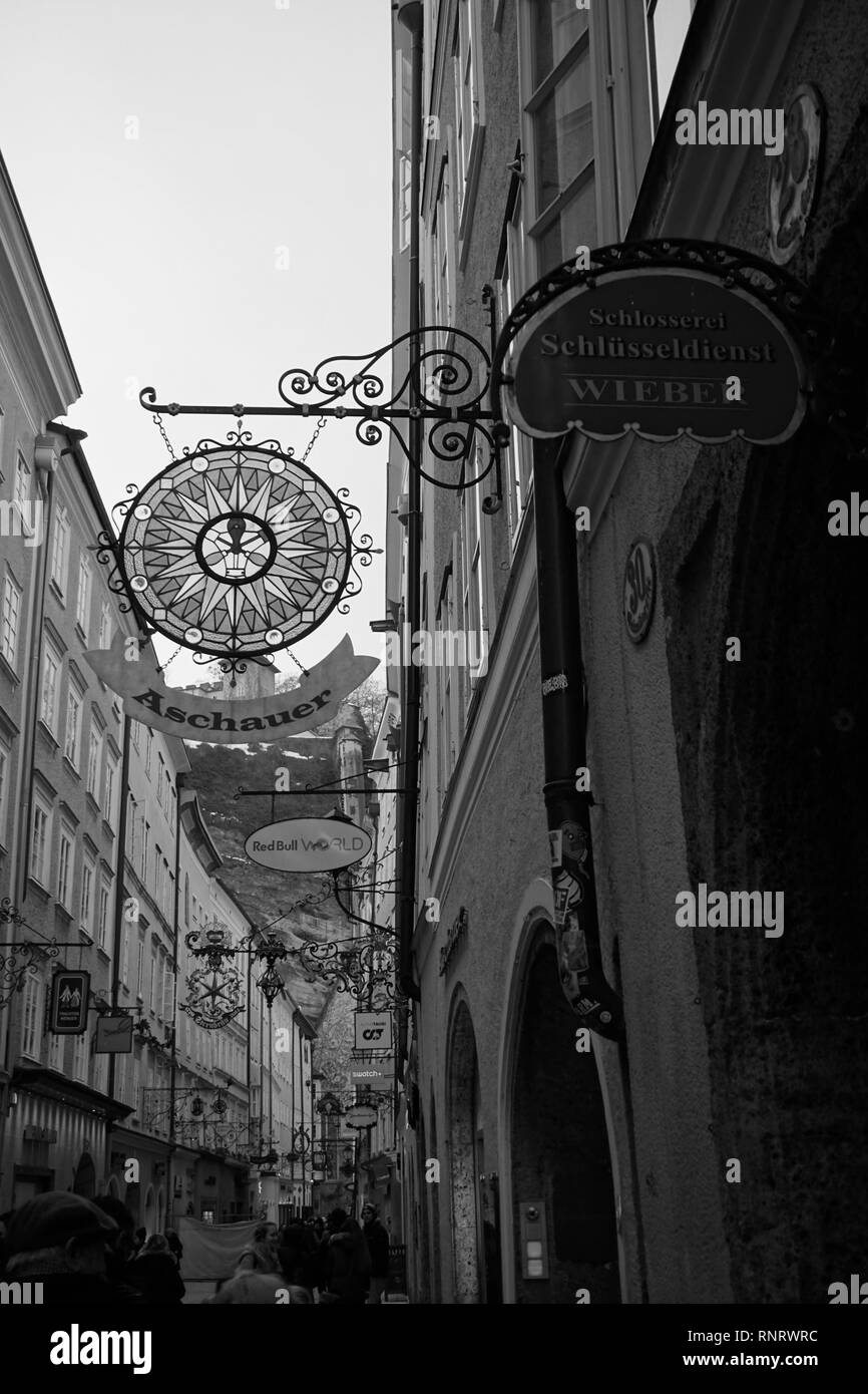Black and white vintage hanging signs on Getreidegasse, the shopping