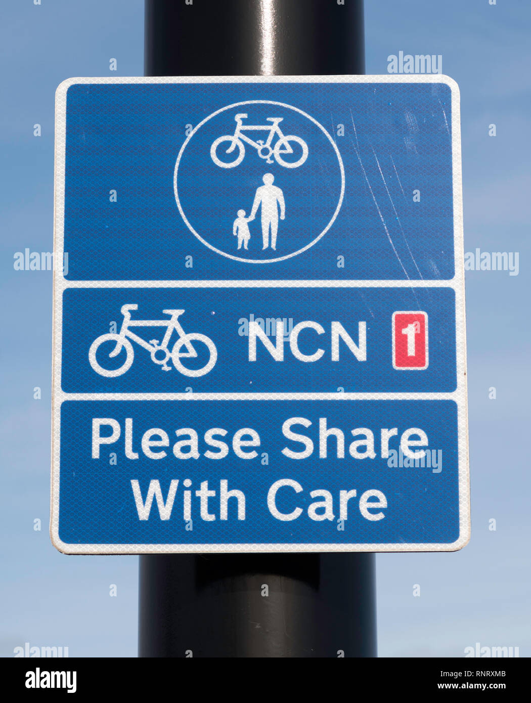 Sign on National Cycle Network NCN 1 shared use cycle and pedestrian path Please Share with Care, in Tynemouth, north east England, UK Stock Photo