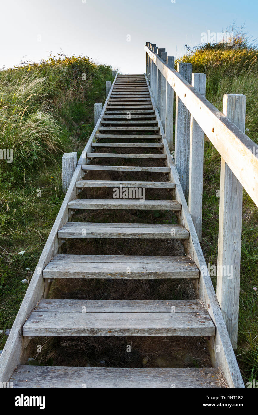 Wooden steps leading up to the south west coast path from the beach at Ringstead Bay, Dorset, England, UK Stock Photo