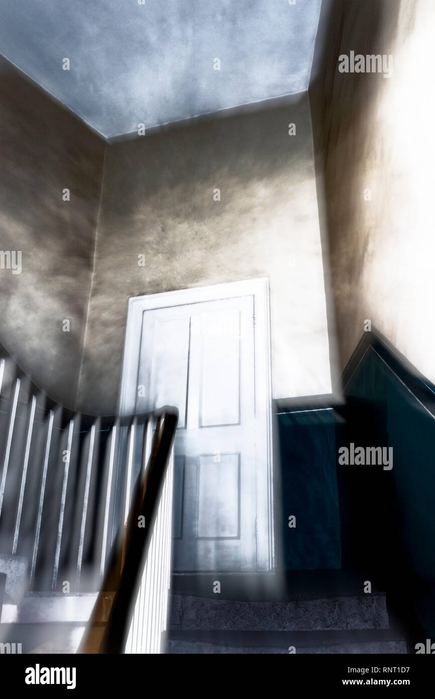 A stylised and atmospheric image of door on the half landing of a spooky staircase in a Victorian house Stock Photo
