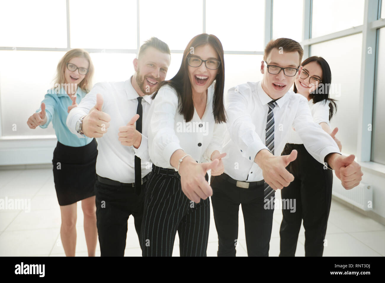 fun business team showing their thumbs up Stock Photo - Alamy