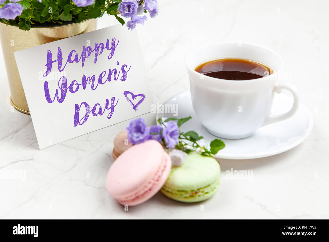 Happy Women's Day postcard note on white marble table Stock Photo ...