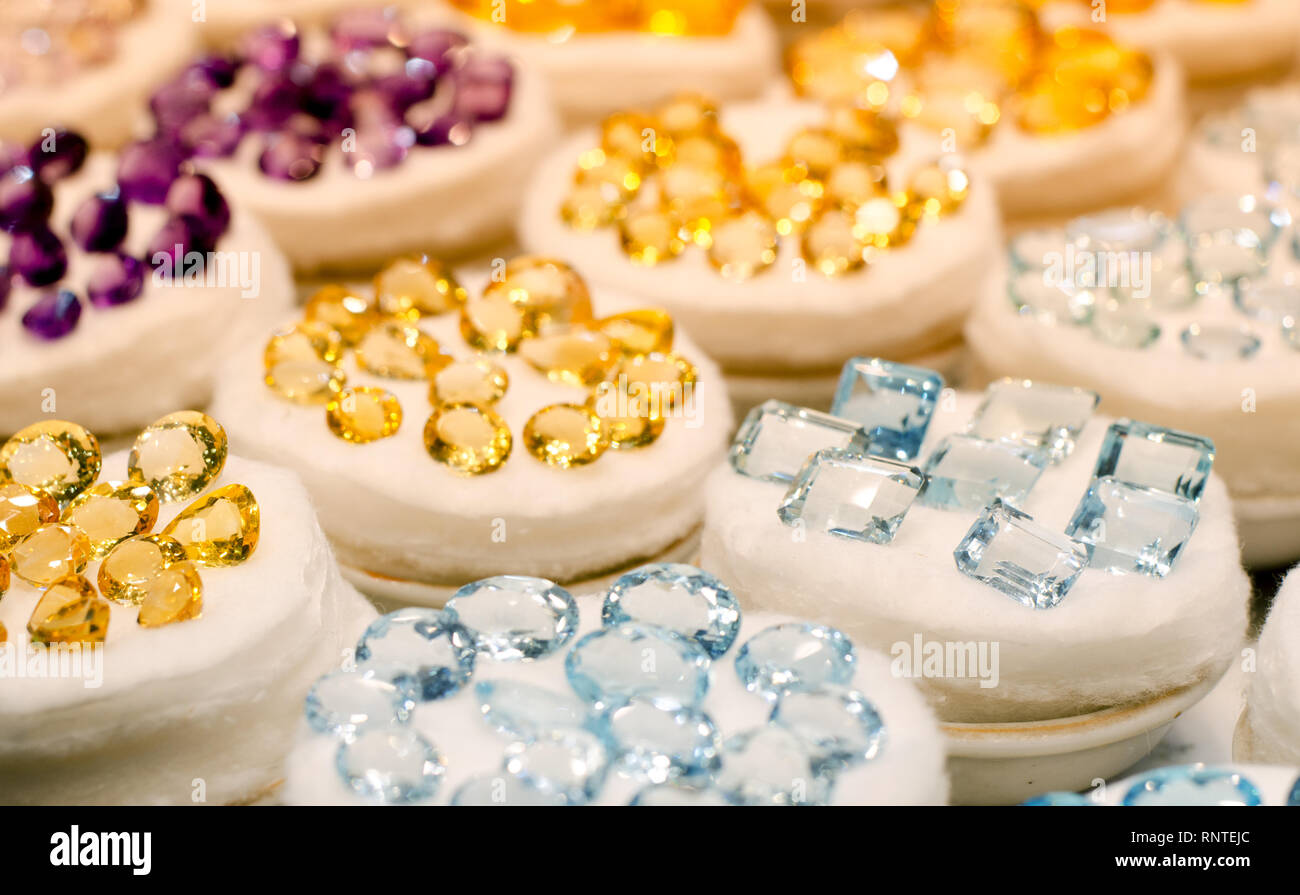 Colorful of different gemstones on a shopfront: amethyst, citrine, ruby and topaz. Stock Photo