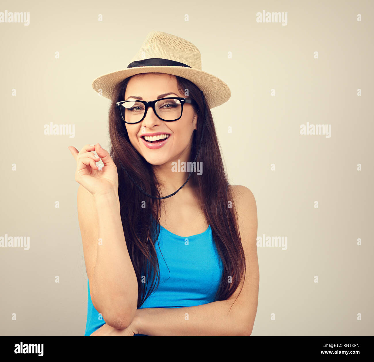 Happy young woman looking in fashion glasses and straw hat have a great