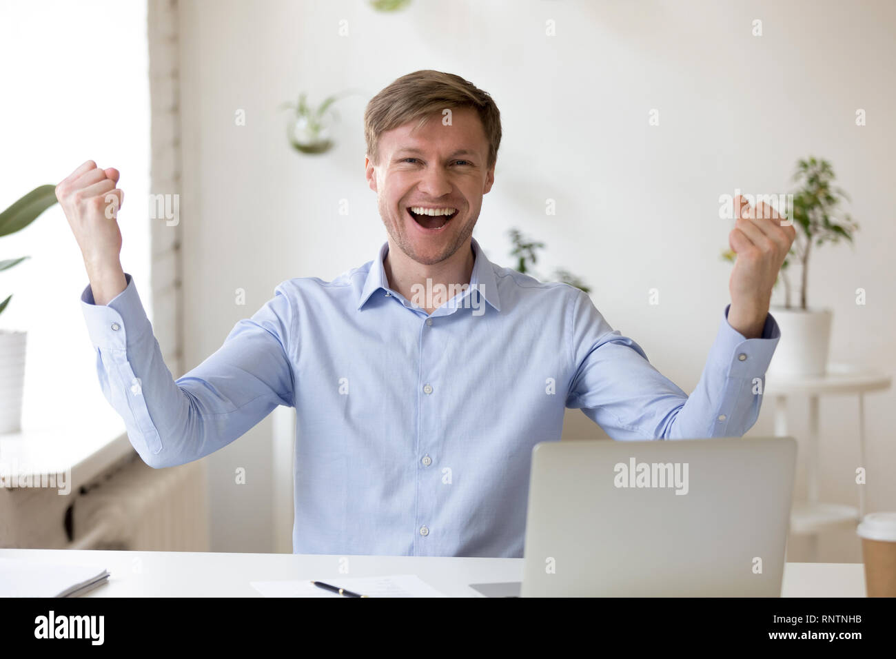 Happy Employee Looking At Camera Excited By Great News Stock Photo