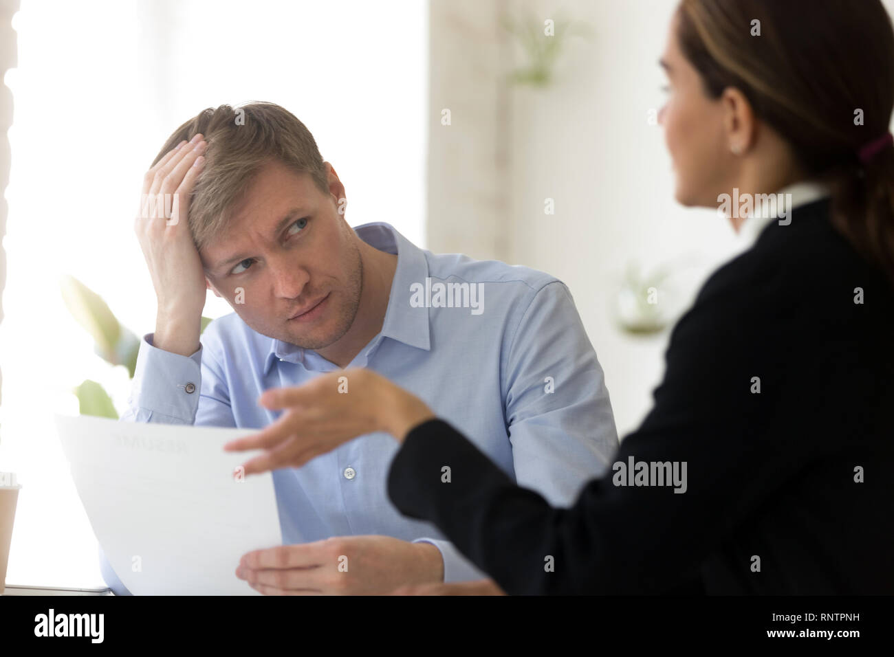 Confused hr manager and female applicant negotiating Stock Photo