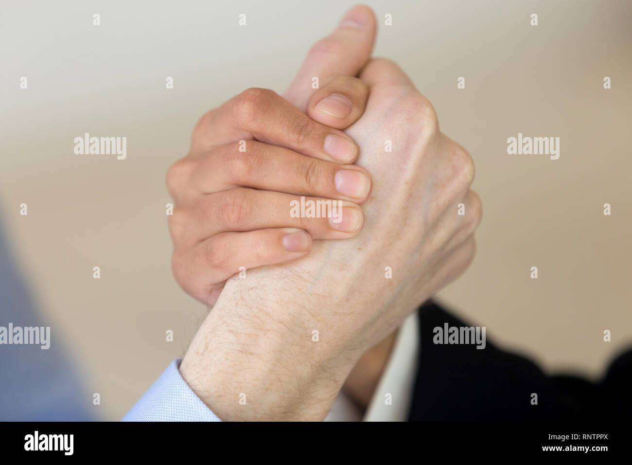 Close up of woman and man arm wresting Stock Photo