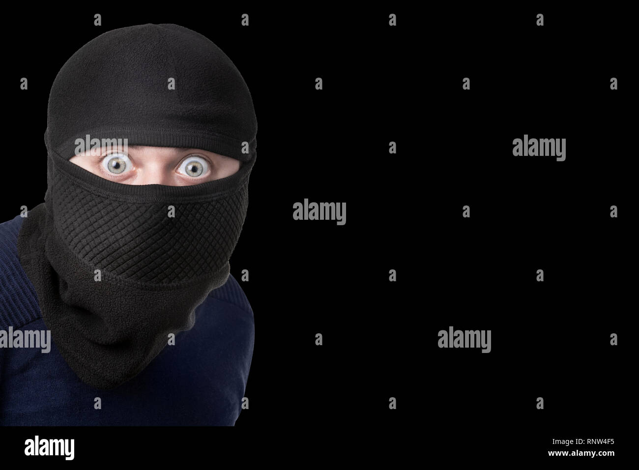shocked man in balaclava at crime scene, image on black background